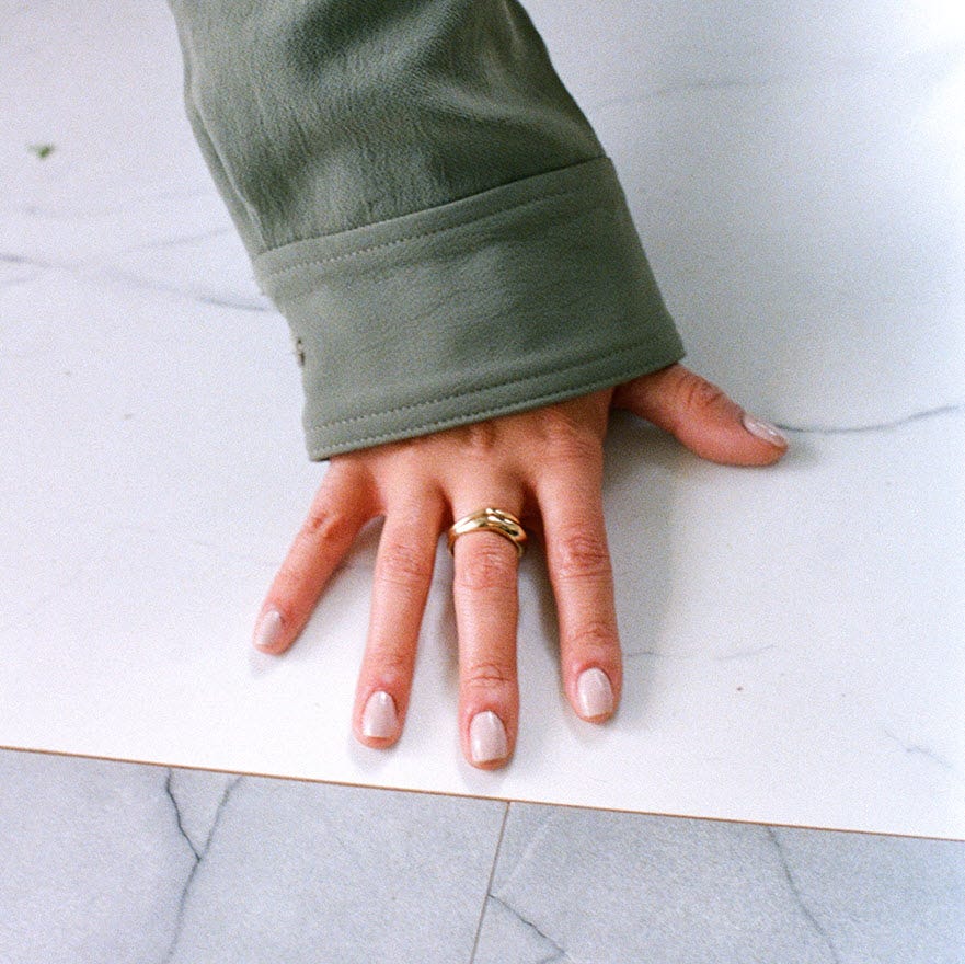 Woman's hand overlay on top of Tiles by PURLINE, North American brand partner to Matter Surfaces. 